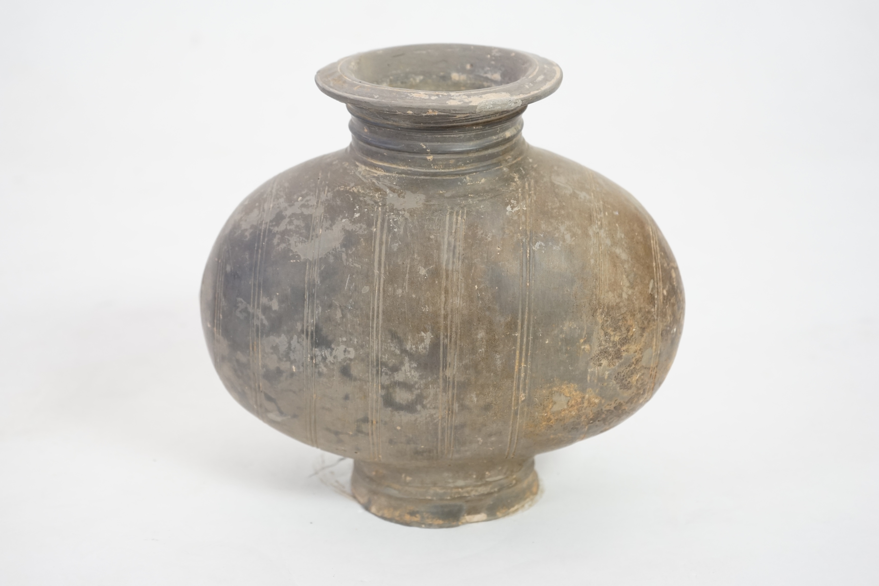 A Chinese incised and burnished pottery cocoon jar, Western Han Dynasty (206 BC-AD 8)